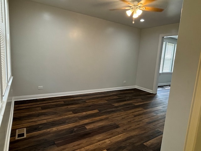 unfurnished room featuring ceiling fan and dark hardwood / wood-style flooring