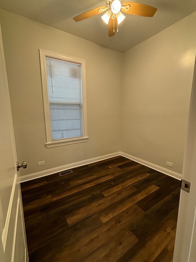 empty room with ceiling fan and dark hardwood / wood-style floors