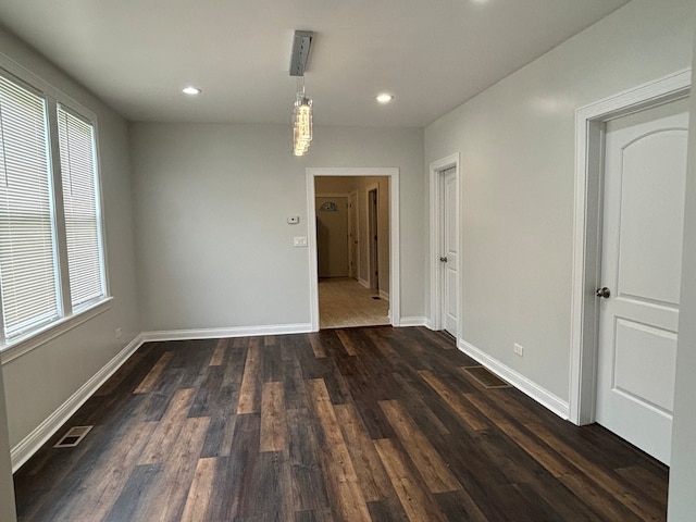 spare room featuring dark wood-type flooring