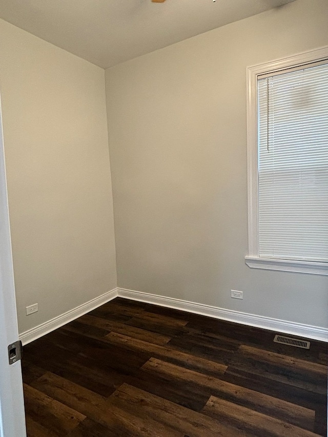 empty room featuring dark hardwood / wood-style flooring