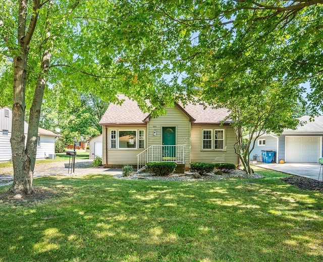 view of front of home featuring a garage and a front lawn