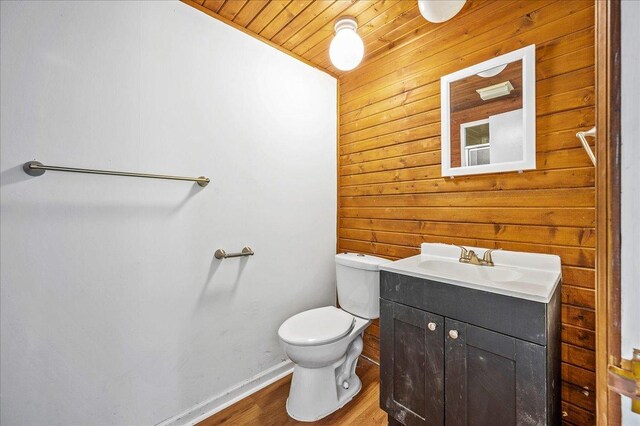 920 S 5th St, Watseka, IL 60970 - bathroom featuring vanity, toilet, wood ceiling, wood finished floors, and wood walls