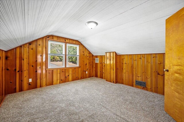 920 S 5th St, Watseka, IL 60970 - additional living space with visible vents, wood walls, lofted ceiling, and carpet floors
