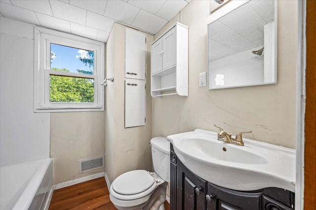 bathroom with vanity, toilet, and hardwood / wood-style flooring