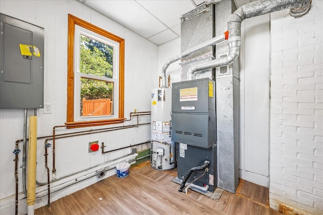 utility room with gas water heater and electric panel