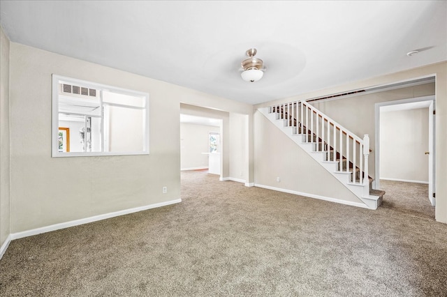 interior space with ceiling fan and carpet