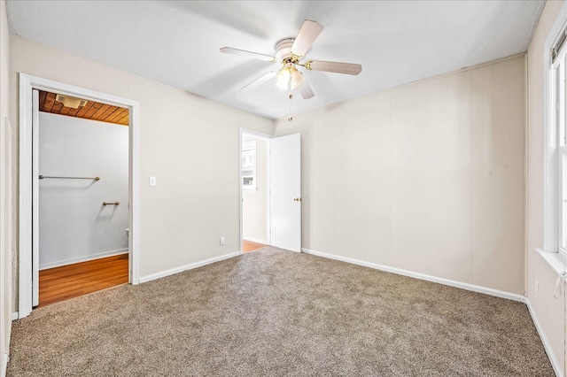 unfurnished bedroom with ceiling fan and carpet