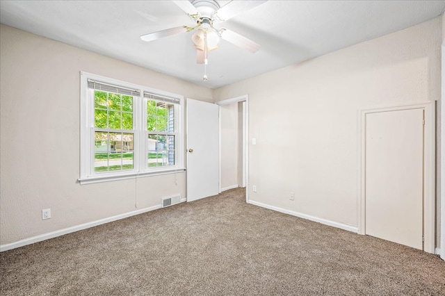 carpeted empty room featuring ceiling fan