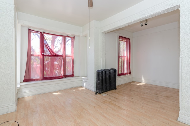 interior space featuring light wood-type flooring and radiator