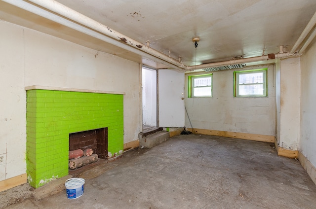 basement featuring a brick fireplace