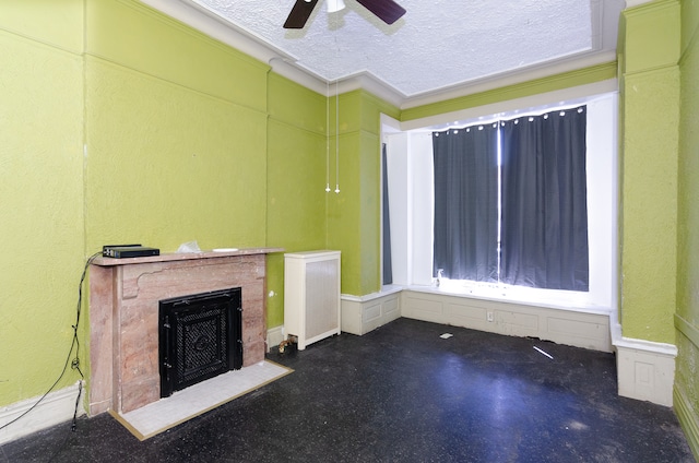 unfurnished living room with a textured ceiling, crown molding, ceiling fan, and radiator heating unit