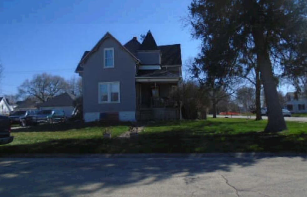 view of side of home with a lawn