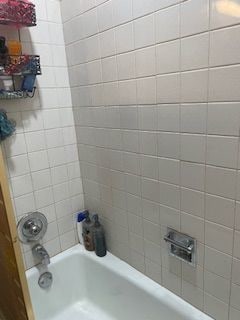 bathroom featuring tiled shower / bath