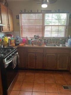 kitchen with tile patterned flooring, stainless steel electric range, ceiling fan, and sink