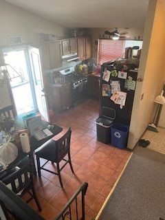 kitchen with ceiling fan, tile patterned floors, and stainless steel range oven