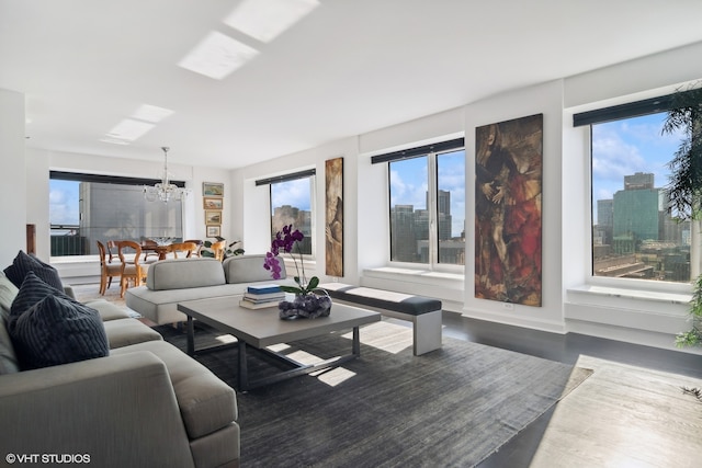 living room with a notable chandelier and hardwood / wood-style floors