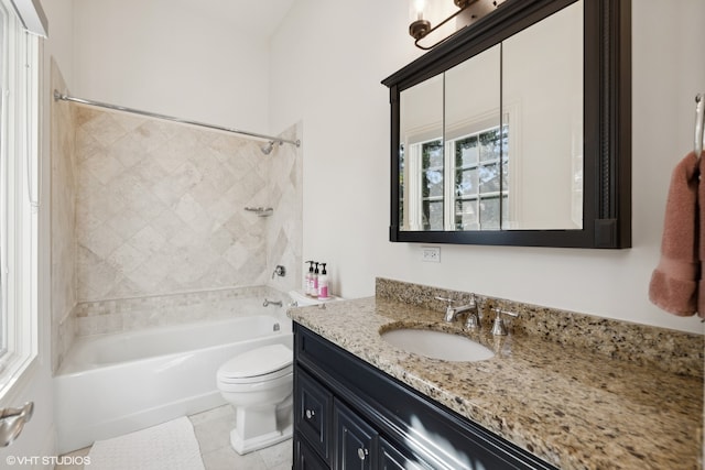 full bathroom with tiled shower / bath, tile patterned floors, vanity, and toilet