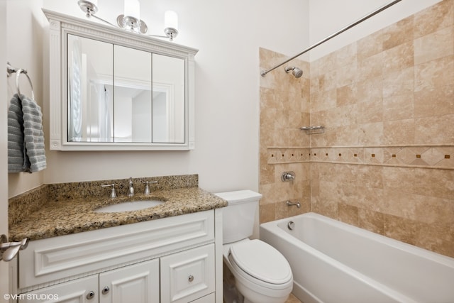 full bathroom with vanity, tiled shower / bath combo, and toilet