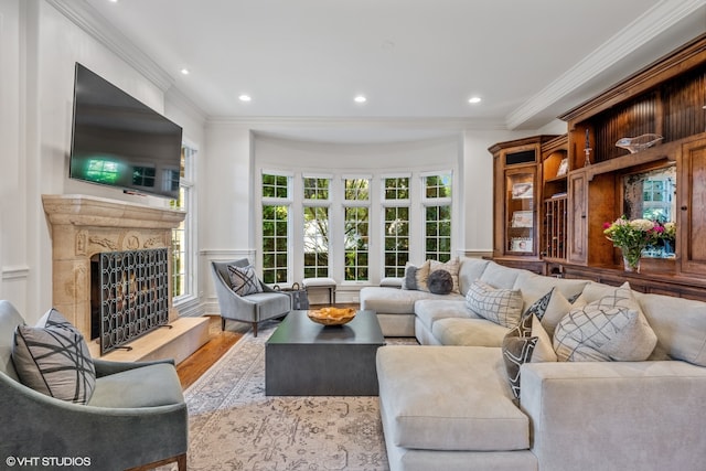 living room with crown molding and light wood-type flooring