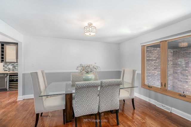 dining room with beverage cooler and wood-type flooring