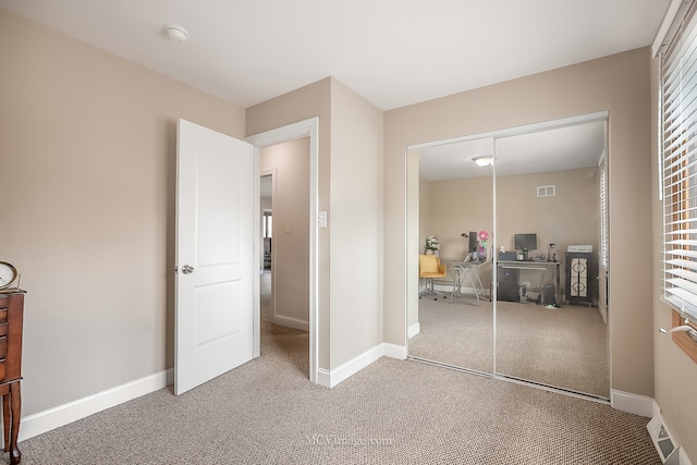 carpeted bedroom with a closet