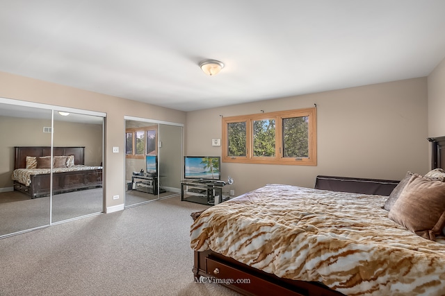 carpeted bedroom with multiple closets