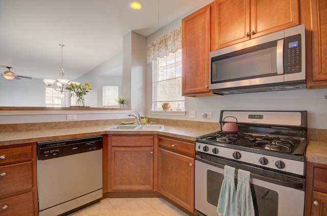 kitchen featuring light tile patterned floors, ceiling fan with notable chandelier, stainless steel appliances, and sink