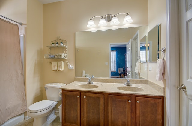 bathroom featuring curtained shower, vanity, and toilet