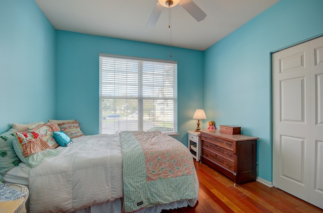 bedroom with ceiling fan, a closet, and hardwood / wood-style flooring