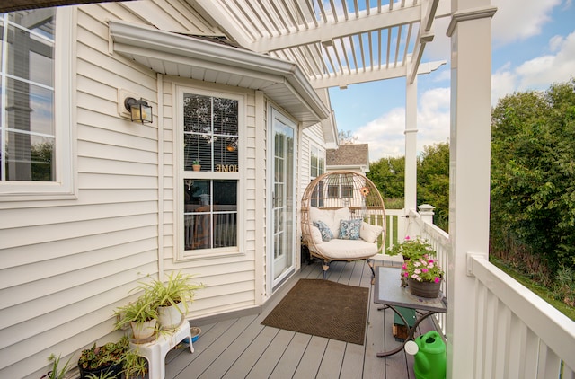 wooden balcony featuring a wooden deck and a pergola