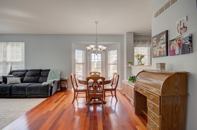 dining space with hardwood / wood-style floors and a wealth of natural light