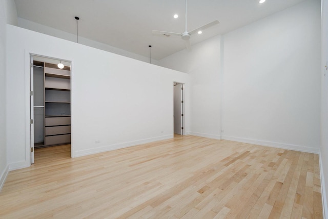 empty room with light wood finished floors, recessed lighting, a ceiling fan, and baseboards