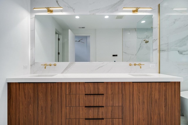 bathroom with double vanity, a sink, and visible vents