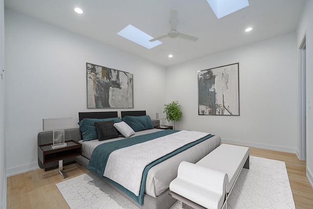 bedroom with recessed lighting, a skylight, and light wood-style floors