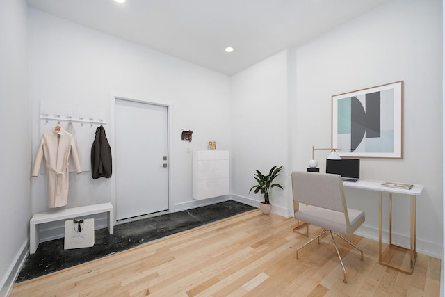 home office featuring baseboards, wood finished floors, and recessed lighting