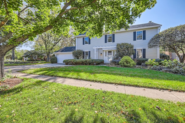 colonial house with a front yard and a garage