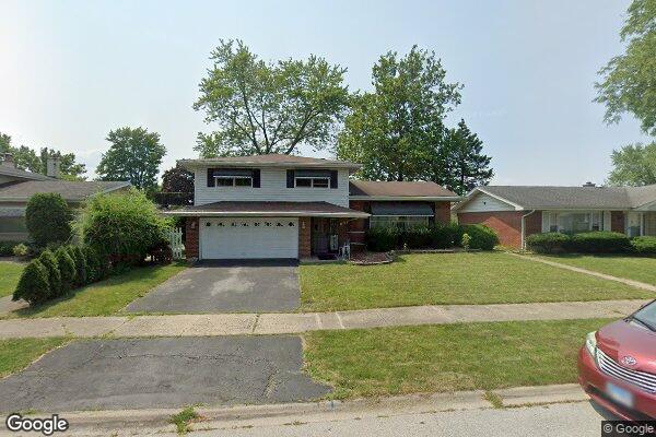 view of front of property with a garage and a front lawn