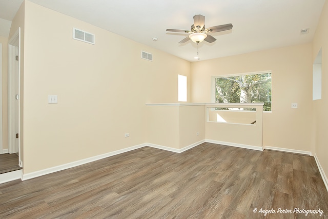 spare room featuring hardwood / wood-style floors and ceiling fan