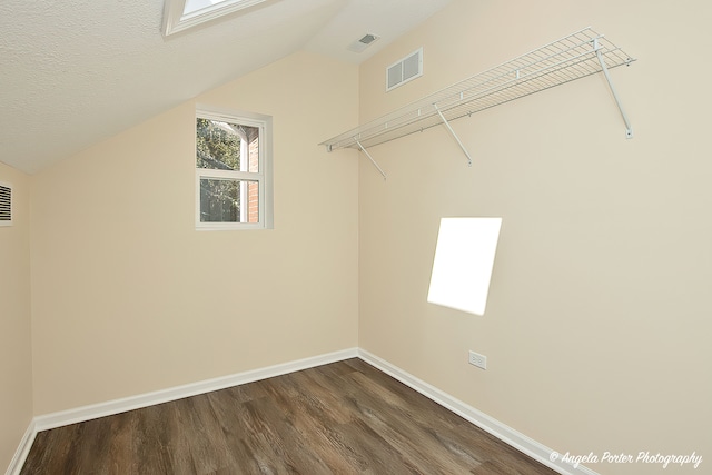 walk in closet featuring hardwood / wood-style flooring and vaulted ceiling