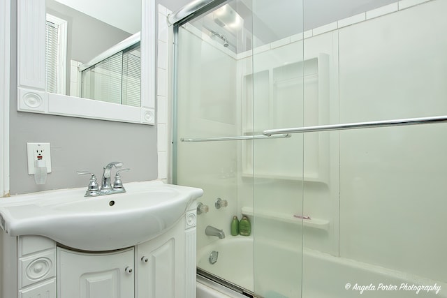 bathroom with combined bath / shower with glass door and vanity