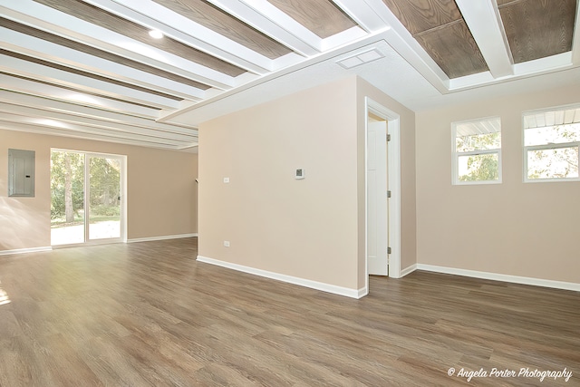 empty room with electric panel and hardwood / wood-style floors