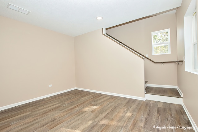 stairs featuring hardwood / wood-style flooring and a textured ceiling