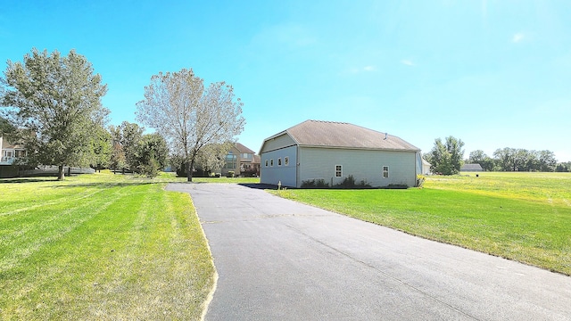 view of property exterior featuring a lawn