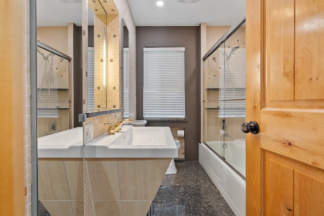 bathroom featuring shower / bath combination with glass door and vanity