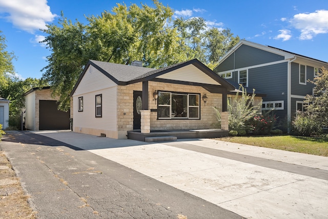 view of front of house featuring an outdoor structure and a garage