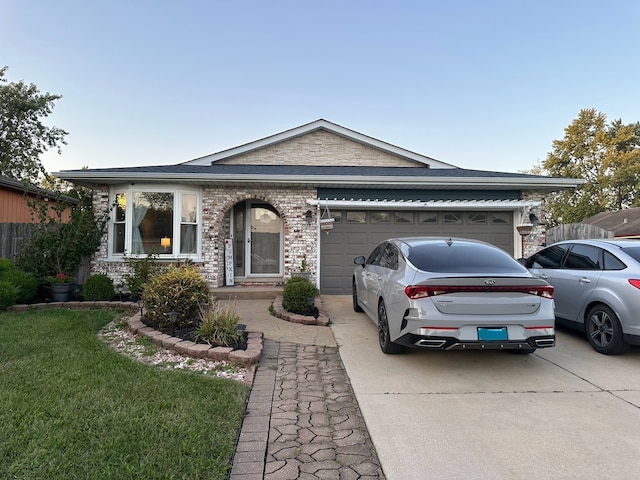 ranch-style home featuring a garage and a front lawn