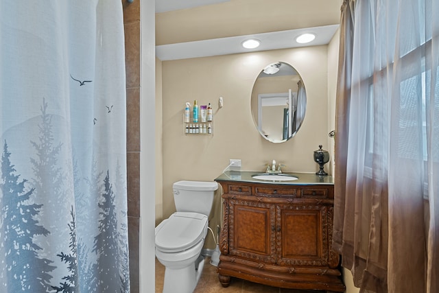 bathroom with curtained shower, tile patterned flooring, vanity, and toilet