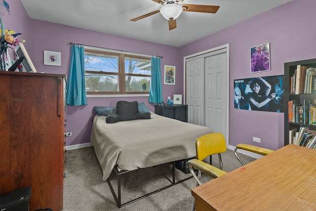 carpeted bedroom featuring ceiling fan and a closet