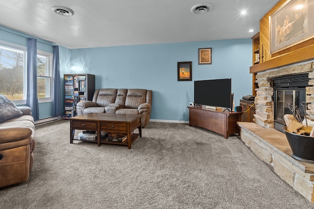 living room featuring carpet flooring and a stone fireplace