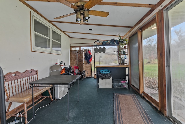 sunroom with ceiling fan and lofted ceiling with beams